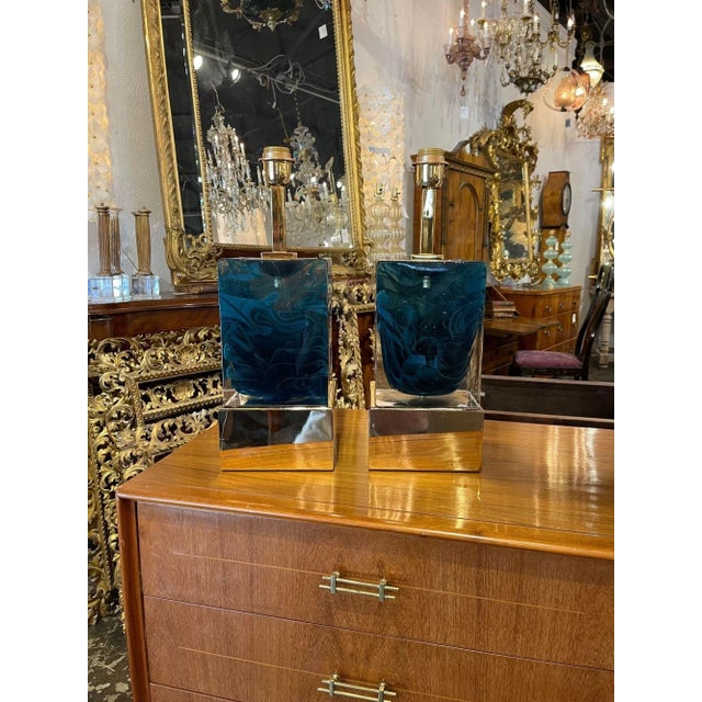 Gorgeous pair of modern blue Murano glass block lamps on a polished brass base. Featuring a vibrant color on the glass and...