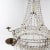 Large ceiling chandelier with six brass candle holders. The hanging of glass prisms, drops and beads is guided over two...