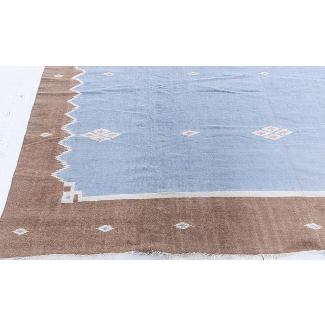 This elegant 1950s Indian Dhurrie rug exemplifies the timeless simplicity and refined craftsmanship associated with...