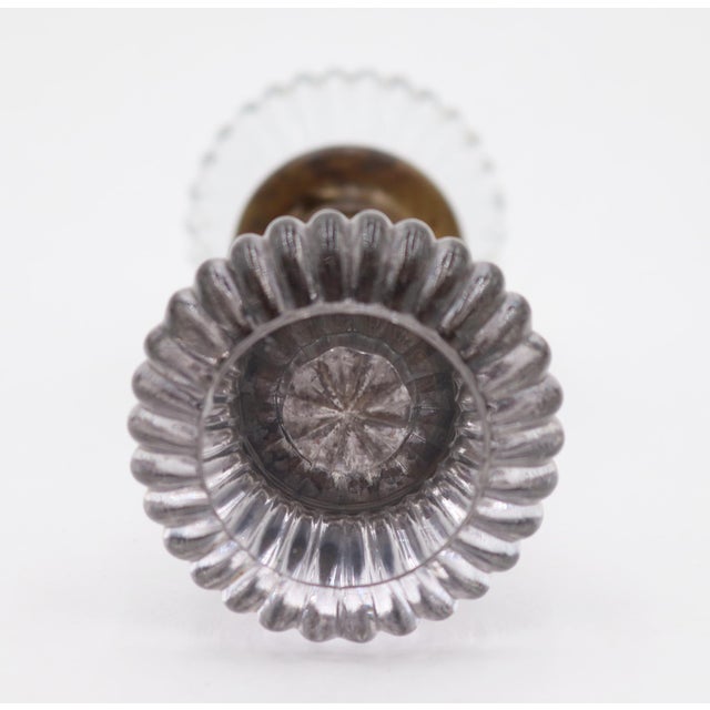 Vintage fluted shaped clear glass door knobs with a brass shank. Priced as a pair of knobs with a spindle. Good condition...