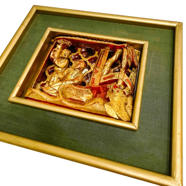 An exquisite hand-carved openwork wood panel depicting a traditional courtyard scene. The carving showcases two figures...