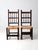 .This is a pair of early 20th century rush seat chairs. The rustic Spaniard style side chairs feature decorative turned...