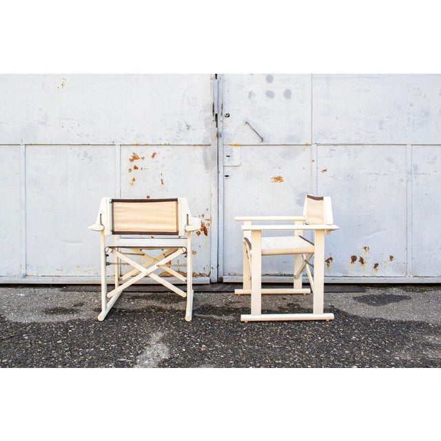 Folding armchair in lacquered wood, fabric seat and backrest. Hollywood model Designer Carlo Hauner Manufacturer Fratelli...