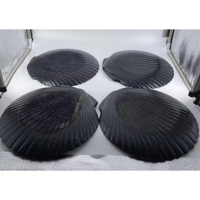 Striking and sculptural, this set of four vintage Arcopal dinner plates showcases the iconic Coquillage clam shell design...