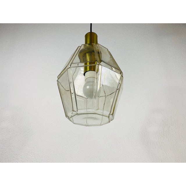 A Mid-Century Modern pendant lamp by Glashütte Limburg made in the 1960s in Germany. It is fascinating with its beautiful...