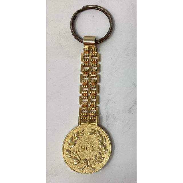 Lovely Judith Leiber gold plated key chain fob or bag charm with image of Ceasar. Dated 1963