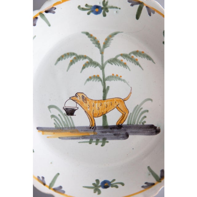 A superb antique 18th-Century French provincial faience Nevers plate. This lovely plate has scalloped edges and is...