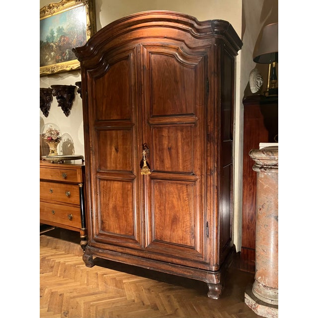 This authentic 18th-century Italian walnut armoire represents the pinnacle of Piedmontese Baroque cabinetmaking, defined...