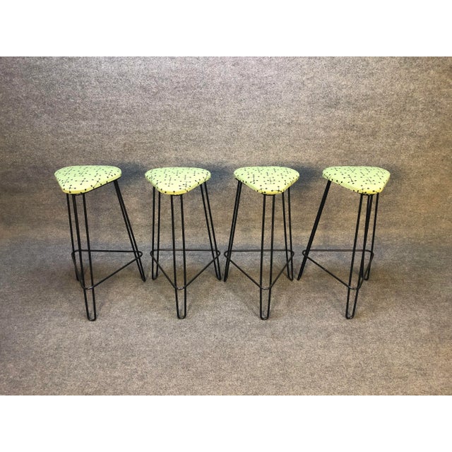 Here is an amazing set of 4 vintage mid century wrought iron bar stools. Bar stools have been reupholstered in the iconic...