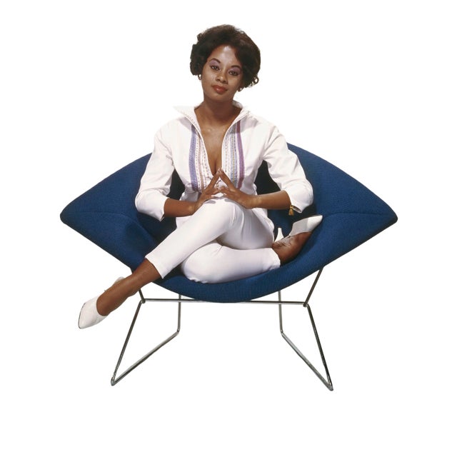 Young woman sitting on armchair, smiling (Tom Kelly Archive/Getty) As an authorized Getty Images Gallery partner, we offer...