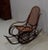Rocking Chair Bent Beech, attributed to the famous cabinetmaker Michael Thonet (1796-1871), which offers the unusual...