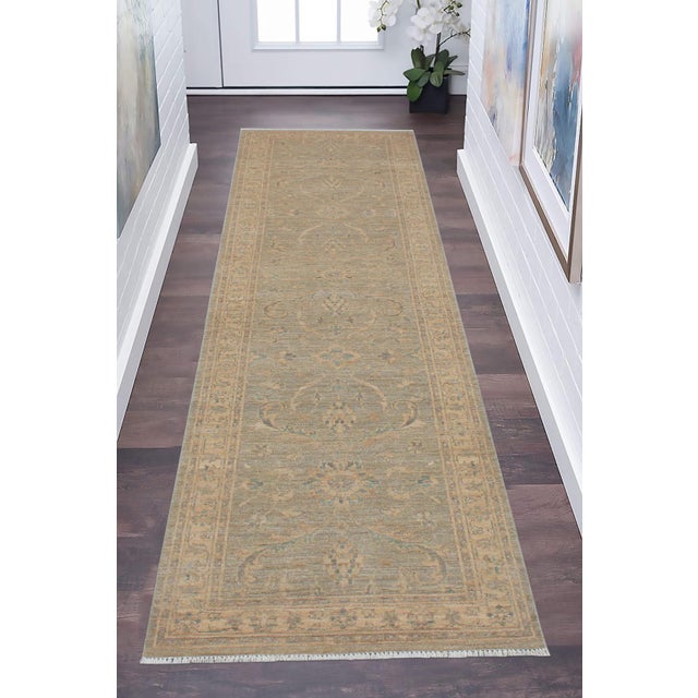 Enhance the ambiance of your home with this magnificent Persian-influenced Turkish hand-knotted rug made by skilled...
