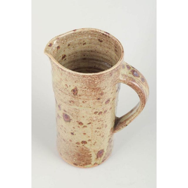 European studio potter Pitcher, 1980s. Unique hand-thrown stoneware pitcher with rustic glaze in beige and brown tones,...