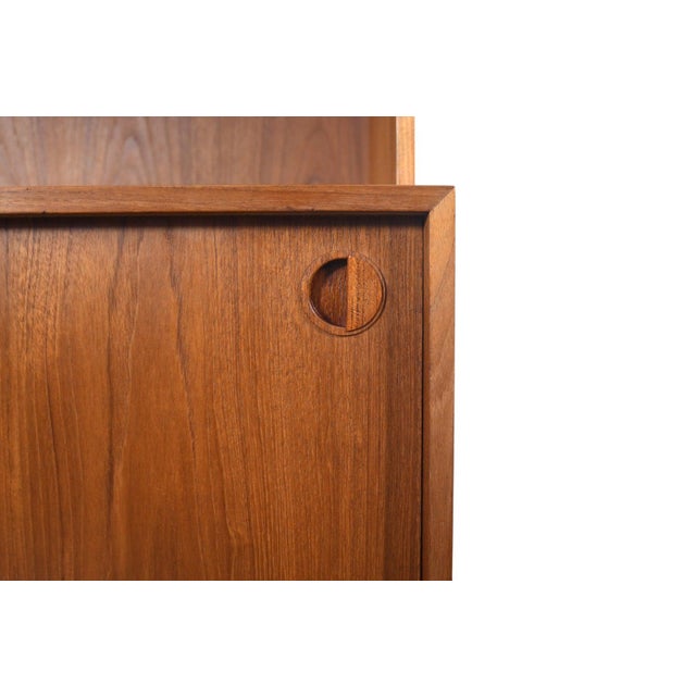 Origin: Denmark Designer: Unknown Manufacturer: Unknown Era: 1960s Materials: Teak, Smoked Glass Measurements: 31.5" wide...