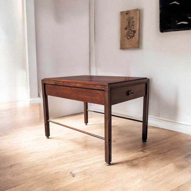 A mid-century modern wood nightstand or end table by Crown City Table Co., designed with a compact rectilinear profile and...