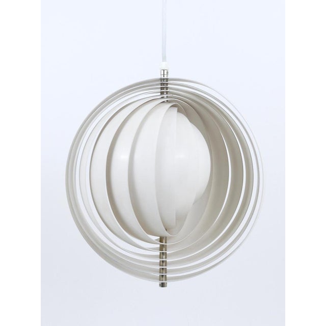 An early model of the iconic Space Age mid-century moon lamp, also known as the visor pendant lamp, designed by Verner...