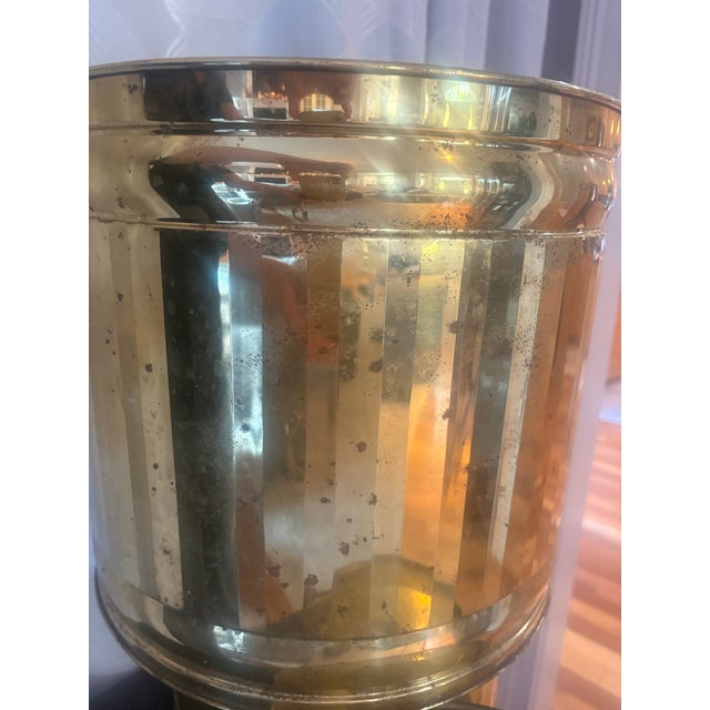 Graduated collection features three complementary cylindrical designs, including hammered and vertically paneled finishes,...