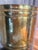 Graduated collection features three complementary cylindrical designs, including hammered and vertically paneled finishes,...