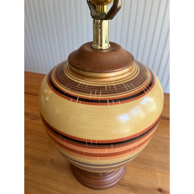 Really stunning and unique vintage Chinese pottery lamp from the Mid-century era. Gorgeous turned wood accents on the...