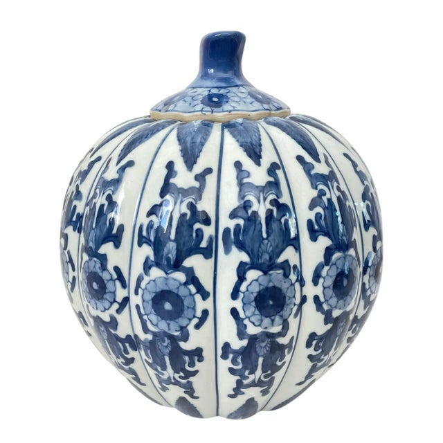 This vintage Chinese porcelain pumpkin is a stunning addition to any collection. With intricate blue and white chinoiserie...