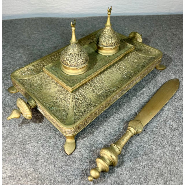 Embossed Middle Eastern desktop inkwell depicting classic hunting scenes and crescent moon stylus holders.
