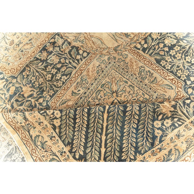 An early 20th century antique Southeast Persian Kirman rug, this stunning piece features an extravagant all-over stepped...