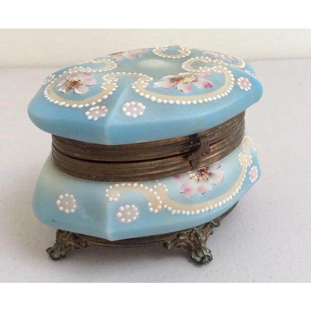 Pretty antique glass box with footed base and metal hinged lid.