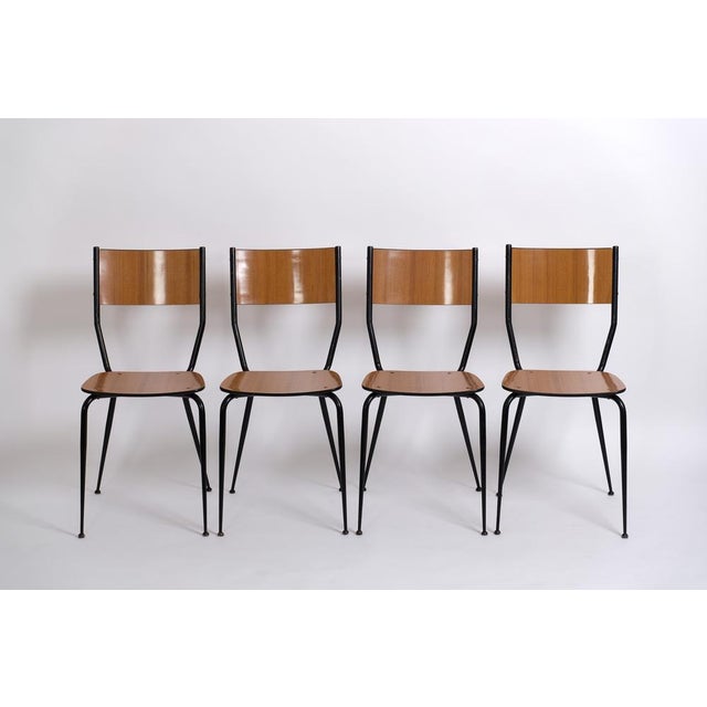 Set of four elegant mid-century dining chairs made of iron and formica. Manufactured around 1950 in Italy. A fantastic set...