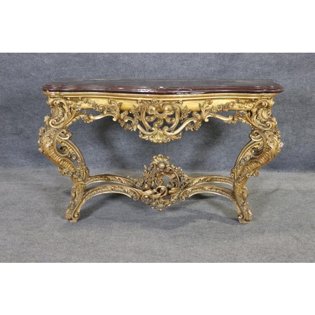 Measures: 38 7/8" h x 72 3/4" w x 24 3/4" d. There is nothing timid about this console. It was born in a century that...