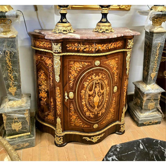 Elevate your interior with this stunning French-style marquetry cabinet, masterfully crafted with intricate floral inlay...