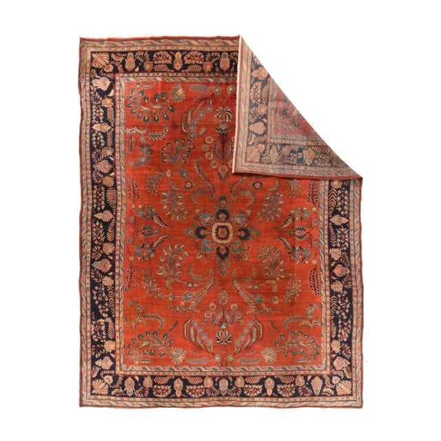 This 1920's Arak Province village carpet shows a warm red field with the period-characteristic detached floral spray...