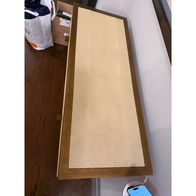 Julian Chichester Frank Console table Rendered in Ivory faux shagreen with Gilded metal legs and trim. Two drawers with...