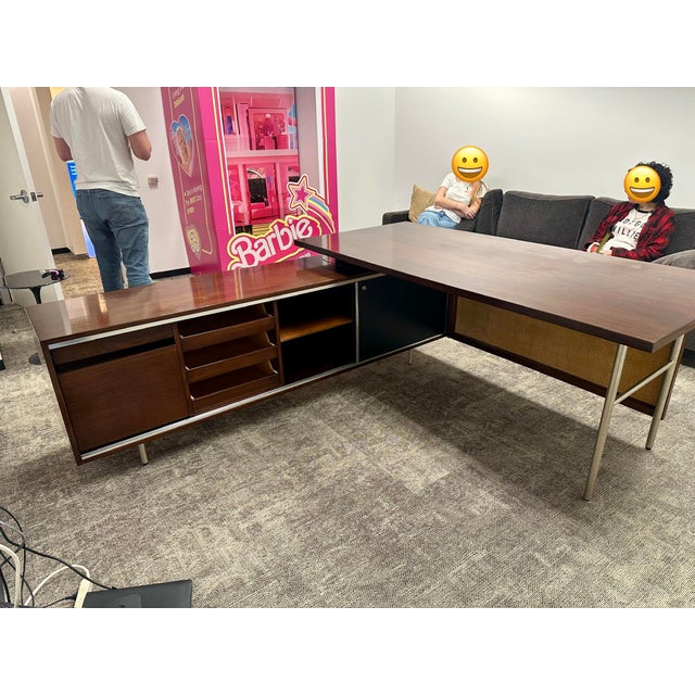 This mid-century modern executive desk, attributed to George Nelson, exemplifies the clean lines, functional elegance, and...