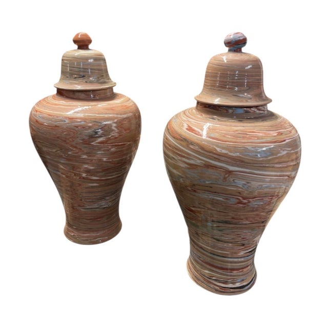Elevate your home decor with this striking pair of vintage ceramic temple jars, featuring an eye-catching marbled glaze...