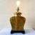Exceptional vintage golden table lamp. Features a sculpted body on a wooden base.