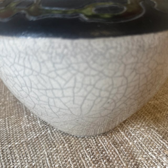 This monumental Raku-fired ceramic vase exemplifies the raw elegance and unpredictability of the ancient Japanese Raku...