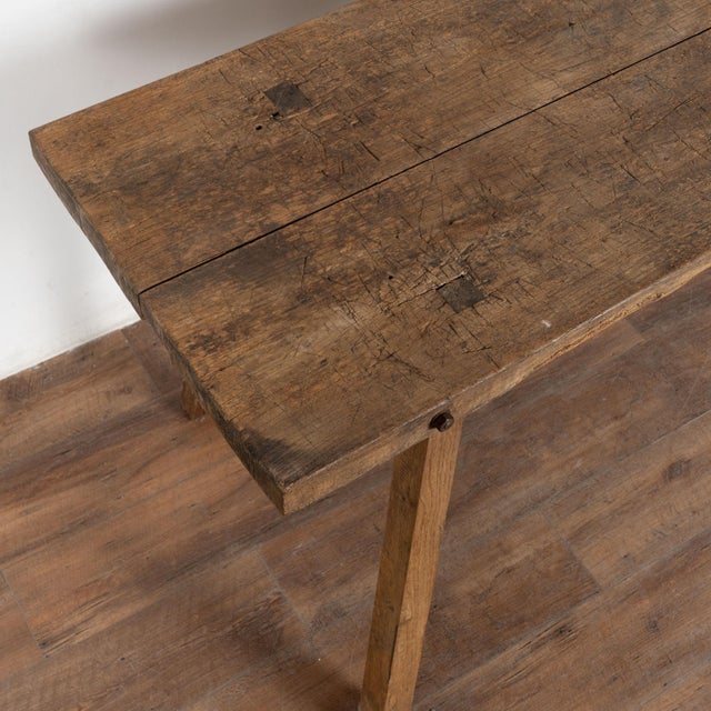 19th century rustic console table crafted in hardwood with squared legs that splay slightly outward. The proportions are...