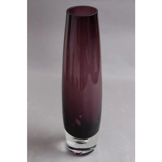 Large Swedish vase in amethyst coloured glass, with air bubble in the foot. The vase looks beautiful with no damage and no...