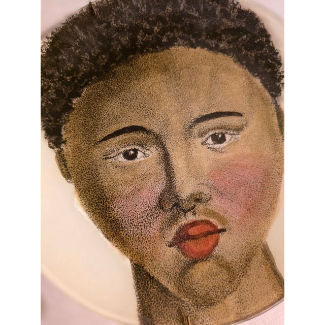 Decorative plate from the John Derian + Astier de Villatte collaboration depicting an image of an African man Made in...