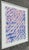 This is a framed abstract watercolor painting on paper with blue brush strokes on a light pink background. The artwork...