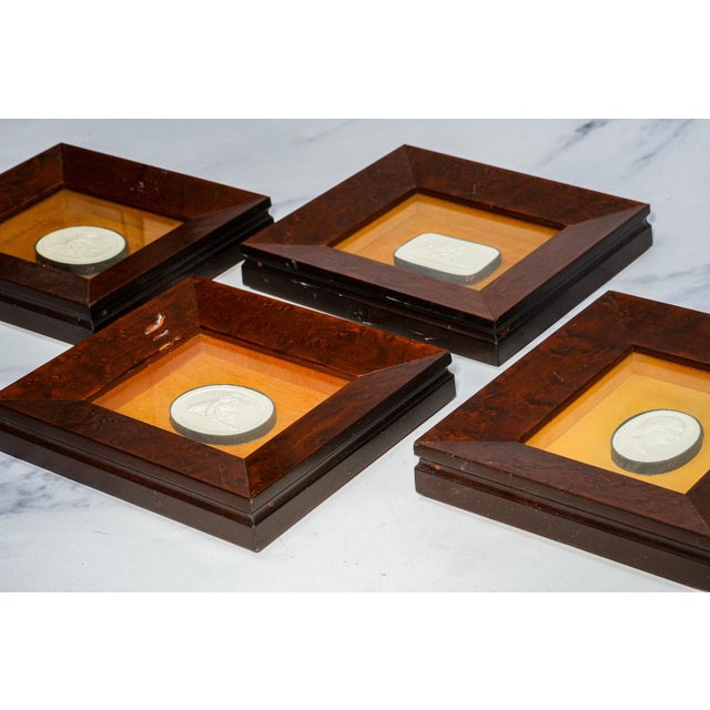 A handsome and highly decorative collection of four 19th-century plaster intaglios, beautifully presented as miniature...