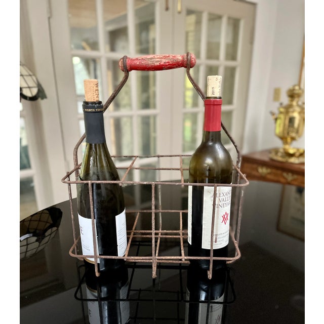 Imported from France. Antique metal bottle carrier with red hand turned wood handle. Originally created for milk bottles,...