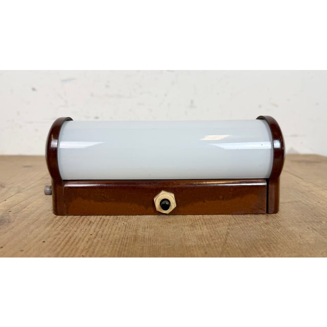 Vintage industrial brown bakelite wall lamp made by Elektrosvit in former Czechoslovakia during the 1950s. It features a...