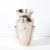 This stunning modernist urn form vase was realized in the United States during the latter half of the 20th century. It...