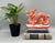 Striking, mid to late 20th century hand-painted Chinese porcelain dragon sculpture featuring a vibrant iron-red glaze with...