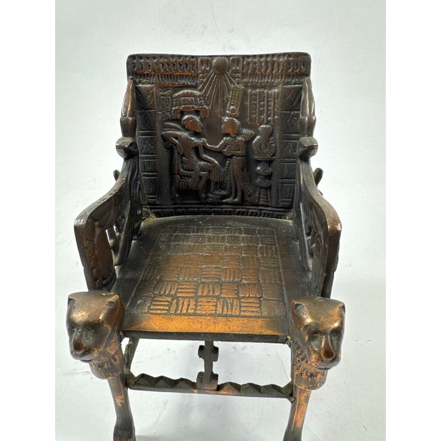 A vintage museum copy in brass of king tuts throne. Such an interesting object to tuck into your bookshelf.