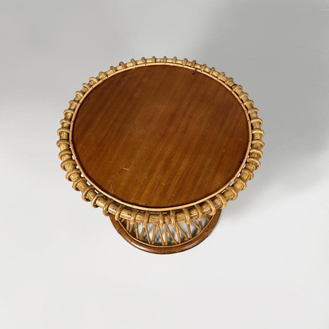 Italian mid-century modern rattan coffe table by Franco Albini, 1960s Coffee table with round wooden top. The woven rattan...