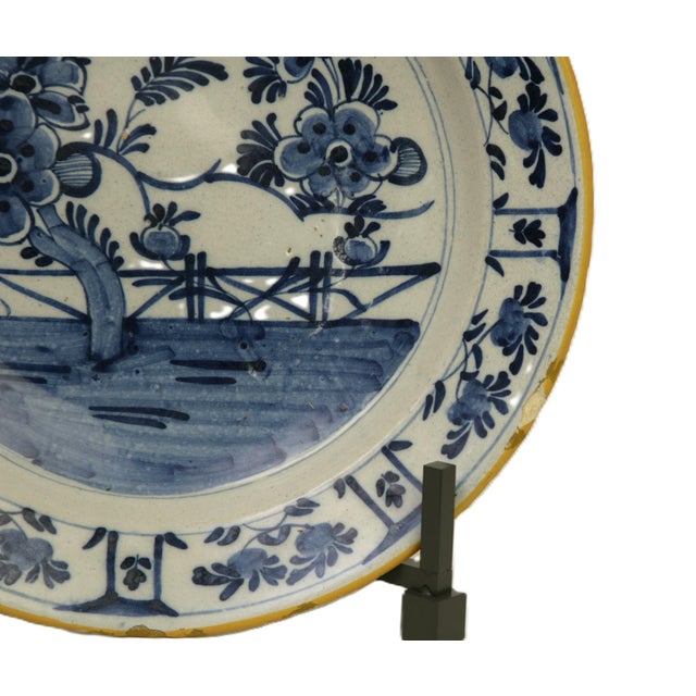 17th century Dutch delft large earthenware plate coated with a white tin glaze to mimic Chinese porcelain. This early...