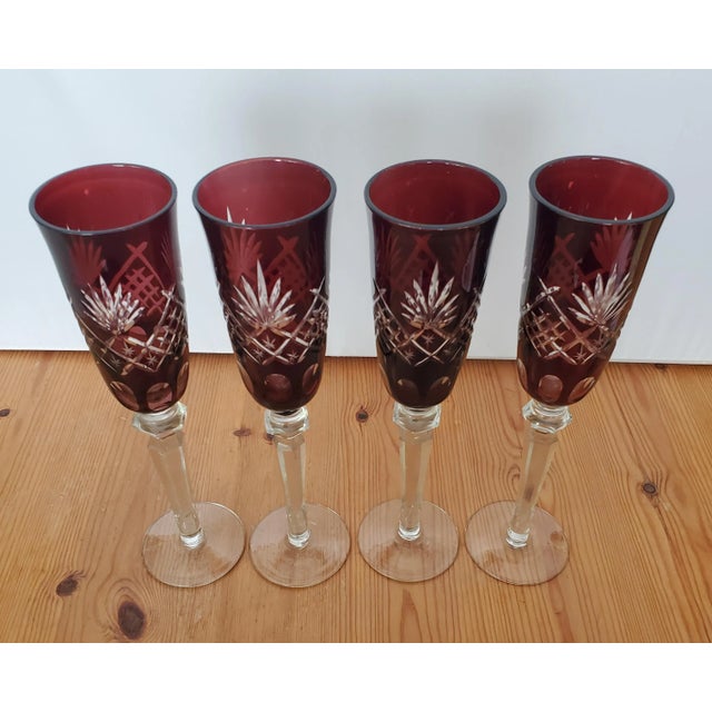 4 matching hand made Bohemian rube red cut to clear champagne flutes