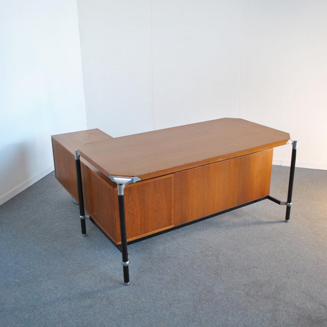 This corner executive desk was designed by Ico Parisi for M.I.M Roma in Italy. The wooden top is connected to black steel...